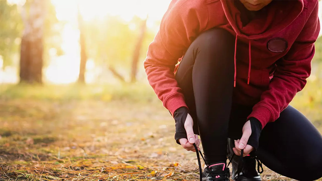woman tying shoe