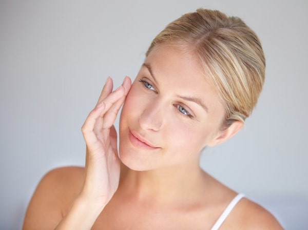 Young woman looking at skin