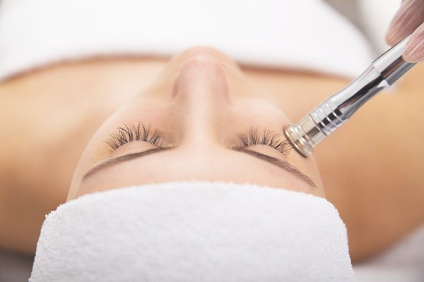 woman receiving facial treatment